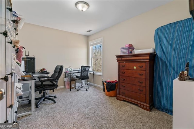 carpeted office with visible vents and baseboards