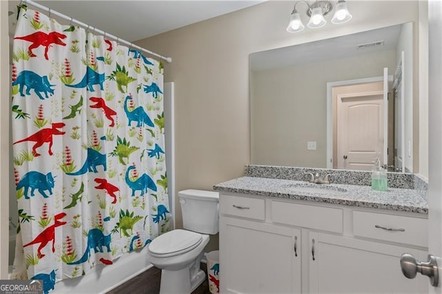 bathroom with visible vents, vanity, and toilet