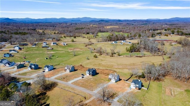 drone / aerial view with a mountain view and a rural view