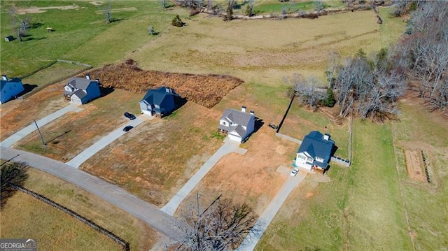 birds eye view of property with a rural view