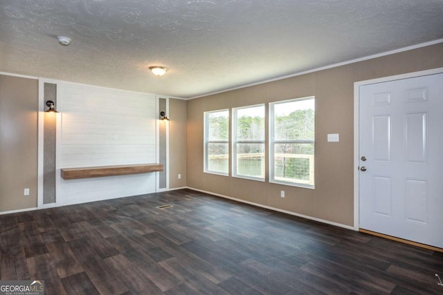 2859 Fortner Rd, Ball Ground, GA 30107 - unfurnished living room featuring a textured ceiling, wood finished floors, baseboards, and ornamental molding