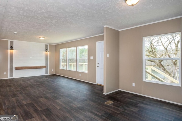 2859 Fortner Rd, Ball Ground, GA 30107 - unfurnished living room with dark wood-type flooring, baseboards, crown molding, and a textured ceiling