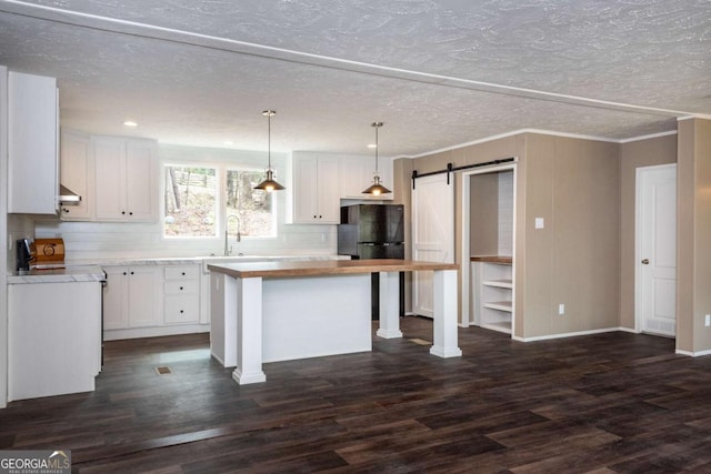 2859 Fortner Rd, Ball Ground, GA 30107 - kitchen with white cabinetry, a barn door, tasteful backsplash, a kitchen island, and dark wood-style floors