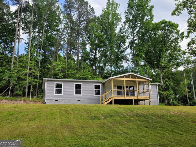 2859 Fortner Rd, Ball Ground, GA 30107 - back of house with crawl space, a lawn, and a deck