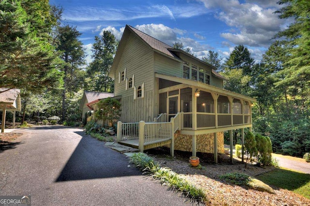 view of front of home featuring a sunroom and driveway