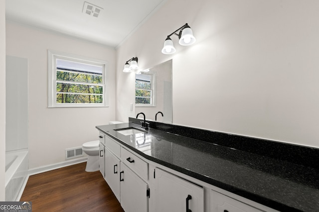 full bath with toilet, visible vents, a wealth of natural light, and wood finished floors