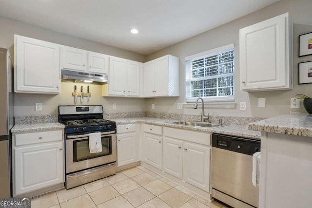 455 Registry Blf, Stone Mountain, GA 30087 - kitchen with stainless steel appliances, under cabinet range hood, a sink, white cabinets, and light tile patterned floors