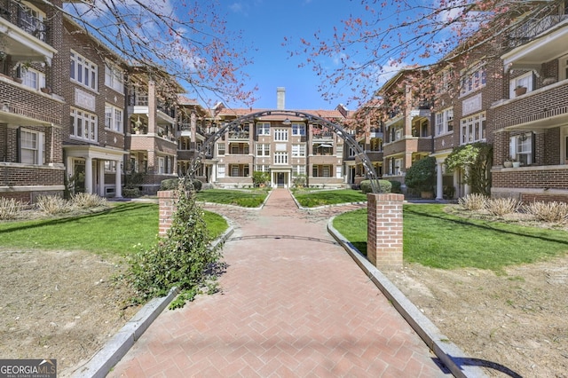 surrounding community with a yard and a residential view