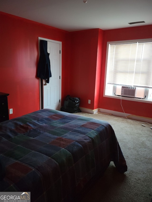 bedroom with carpet, cooling unit, visible vents, and baseboards