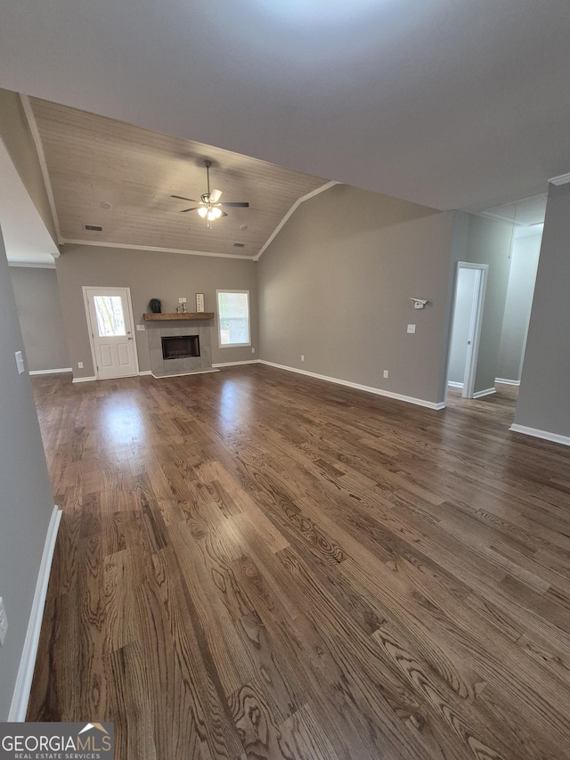 unfurnished living room featuring baseboards, a ceiling fan, lofted ceiling, dark wood-type flooring, and a fireplace