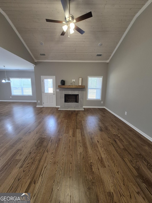 unfurnished living room with ornamental molding, wooden ceiling, and dark wood finished floors