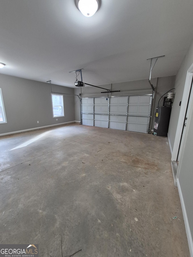 garage featuring a garage door opener, water heater, and baseboards