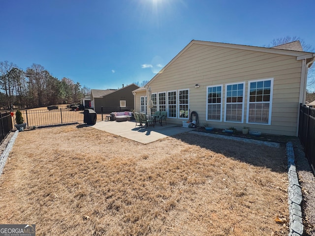 rear view of house with a patio and a fenced backyard