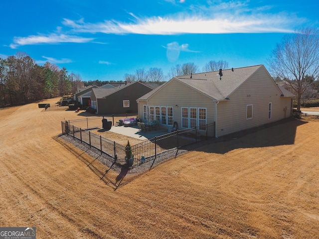 back of property featuring a yard, a patio, and fence
