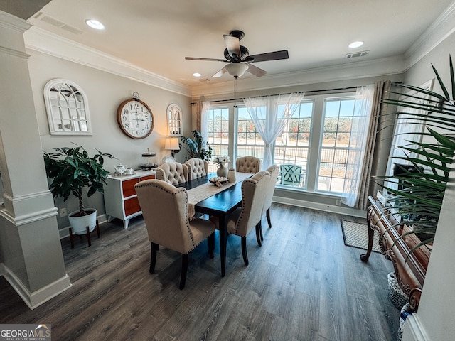 dining room featuring visible vents, dark wood-type flooring, and ornamental molding