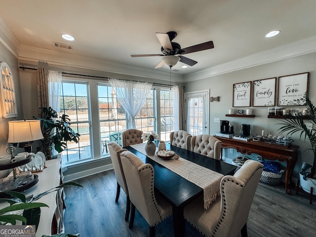 dining space featuring ornamental molding, wood finished floors, visible vents, and a ceiling fan