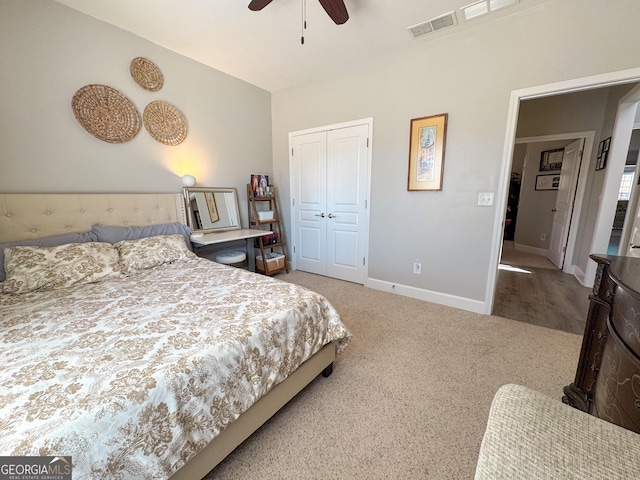 carpeted bedroom with a ceiling fan, visible vents, baseboards, and a closet