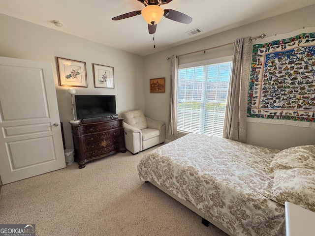 carpeted bedroom featuring visible vents and ceiling fan
