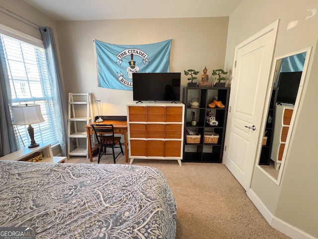 carpeted bedroom featuring baseboards