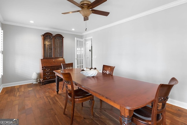 dining area featuring crown molding, baseboards, and hardwood / wood-style flooring