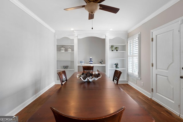 dining room featuring ornamental molding, wood finished floors, built in shelves, and baseboards