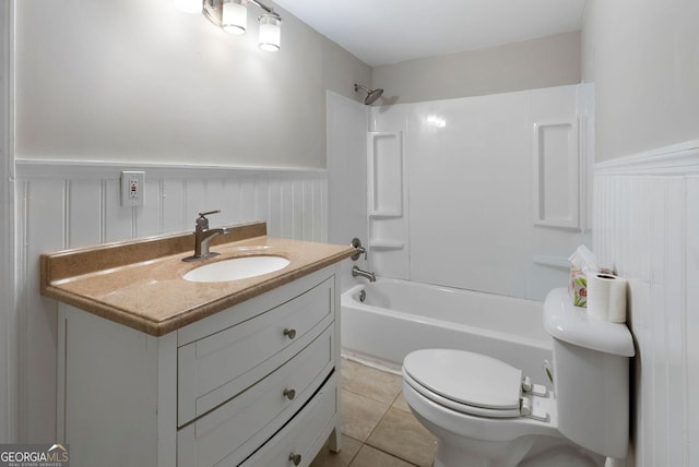 bathroom with a wainscoted wall, tub / shower combination, vanity, and tile patterned floors