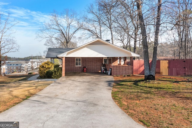 view of front facade with a carport, driveway, brick siding, and a front yard