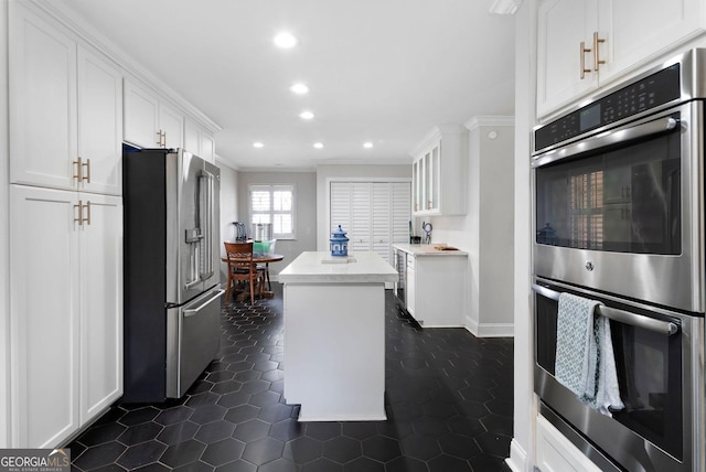 kitchen featuring stainless steel appliances, recessed lighting, a kitchen island, and white cabinets