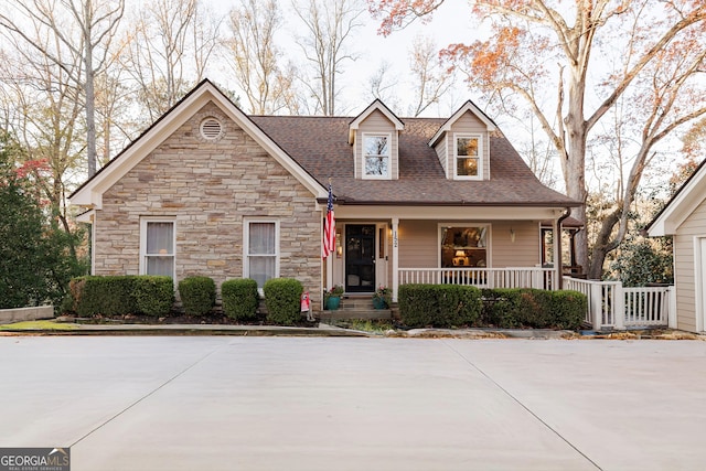 view of front of property featuring a porch and roof with shingles