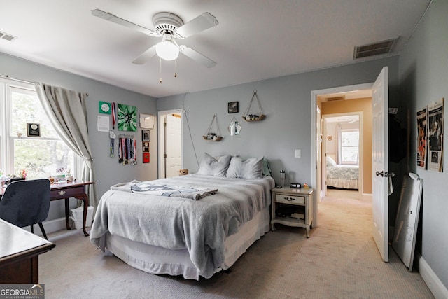 bedroom with light carpet, multiple windows, and visible vents