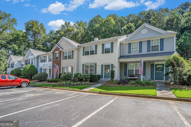 multi unit property featuring uncovered parking and a chimney