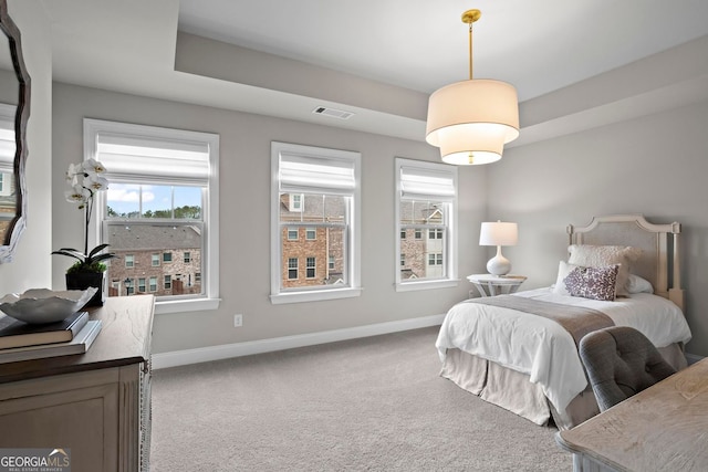 carpeted bedroom with visible vents and baseboards