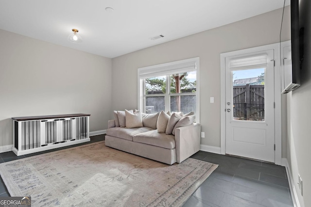 living area featuring visible vents and baseboards