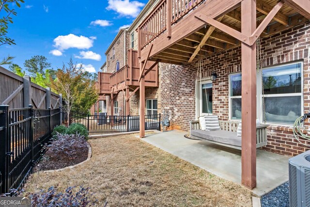 exterior space featuring entry steps, fence, a balcony, and central air condition unit