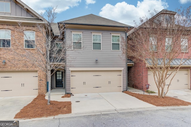 2275 W Village Ln SE, Smyrna, GA 30080 - multi unit property with a garage, board and batten siding, driveway, and a shingled roof