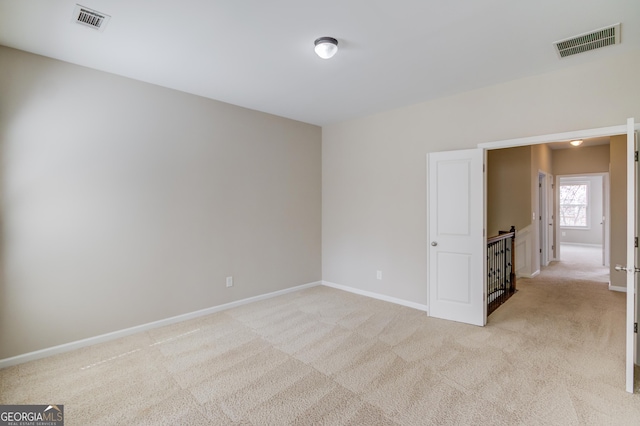 2275 W Village Ln SE, Smyrna, GA 30080 - spare room with baseboards, light colored carpet, and visible vents