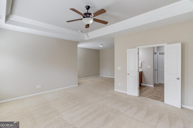 2275 W Village Ln SE, Smyrna, GA 30080 - unfurnished bedroom with crown molding, baseboards, a tray ceiling, and light colored carpet