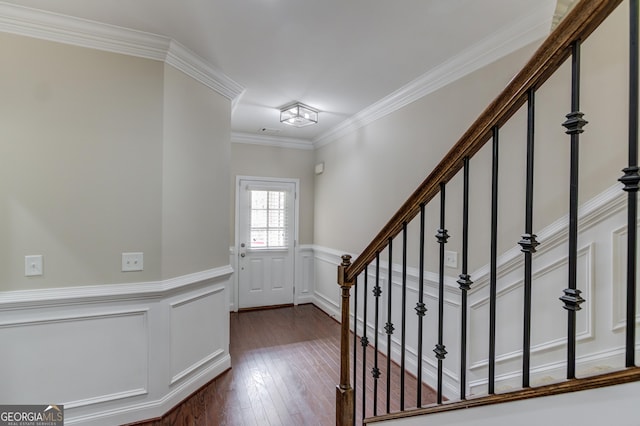 2275 W Village Ln SE, Smyrna, GA 30080 - entrance foyer featuring crown molding, a decorative wall, a wainscoted wall, stairs, and dark wood-type flooring