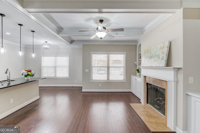 2275 W Village Ln SE, Smyrna, GA 30080 - unfurnished living room with crown molding, dark wood-style flooring, a fireplace, ceiling fan, and a sink