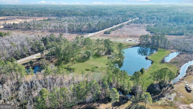 drone / aerial view featuring a water view and a forest view