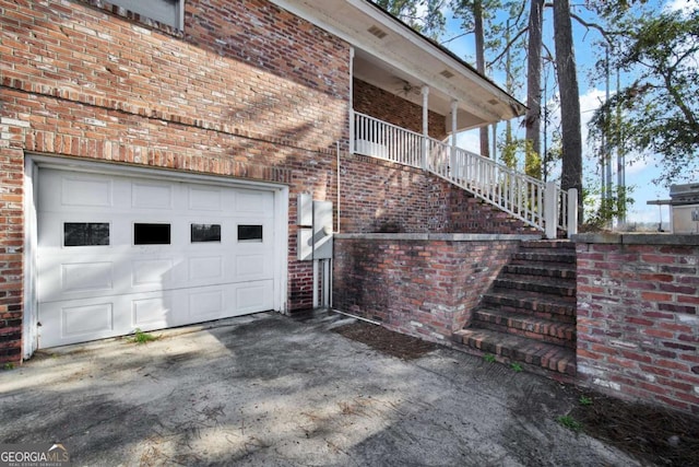 view of home's exterior with a garage, ceiling fan, and brick siding