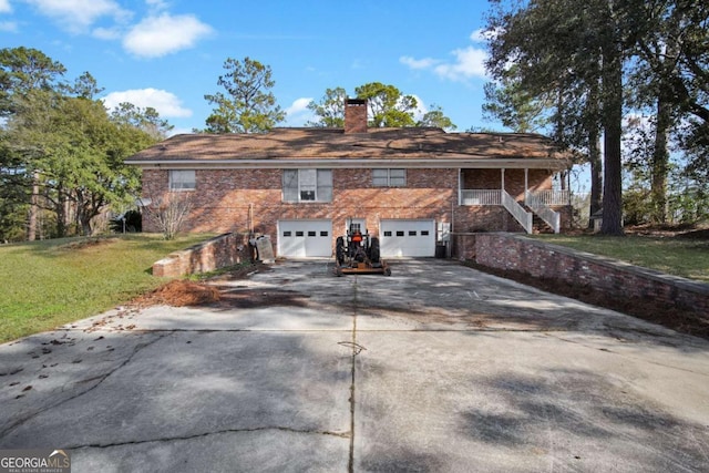 view of front facade featuring a chimney, concrete driveway, stairway, a garage, and a front lawn