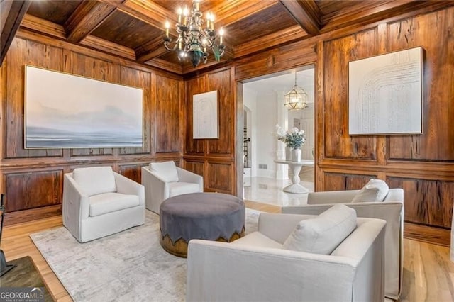 sitting room with wood walls, wooden ceiling, and coffered ceiling