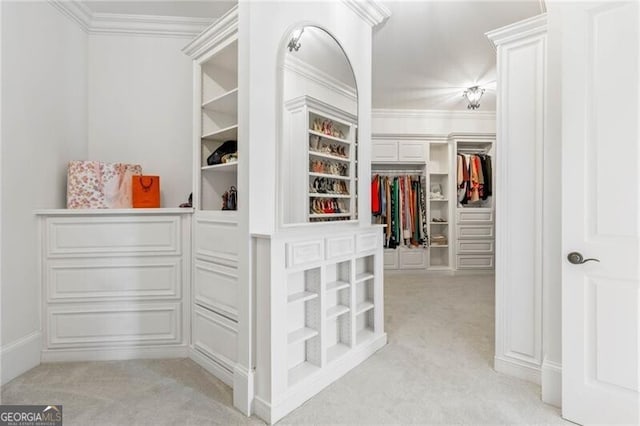 walk in closet featuring light carpet