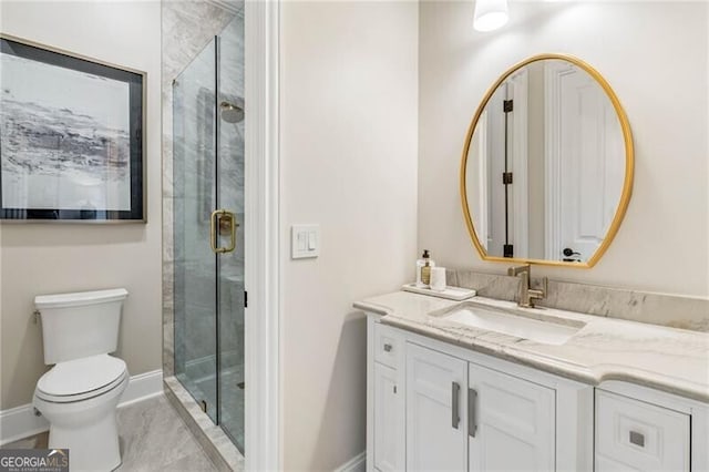 full bath with toilet, a stall shower, baseboards, and vanity