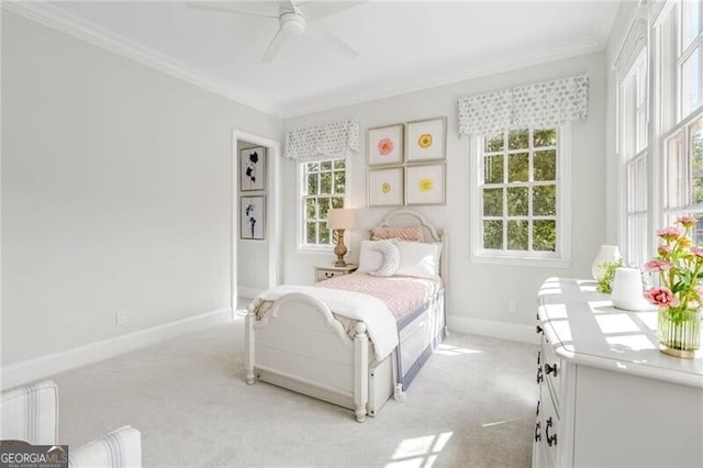 bedroom with baseboards, a ceiling fan, light colored carpet, and crown molding