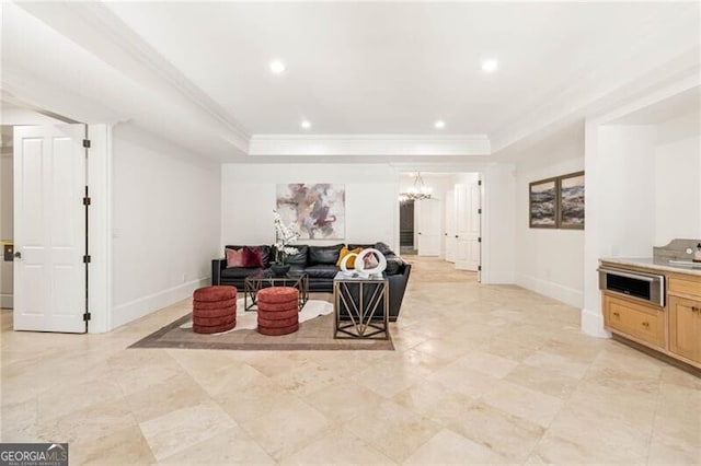 living room featuring recessed lighting, a raised ceiling, crown molding, and baseboards