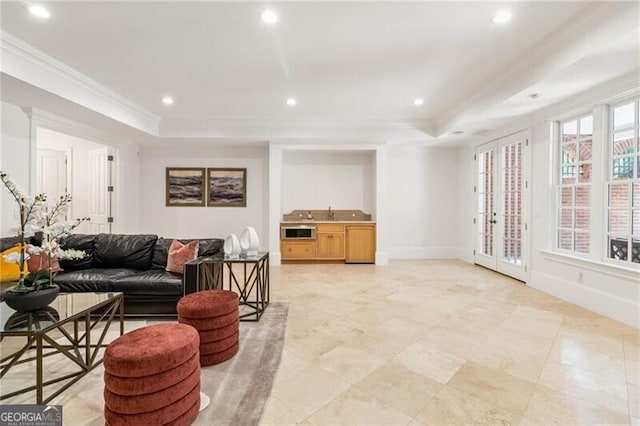 living area featuring baseboards, a raised ceiling, crown molding, and recessed lighting