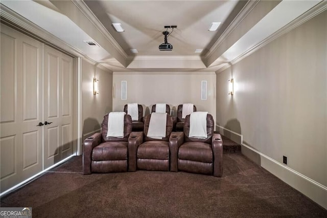 cinema featuring visible vents, baseboards, ornamental molding, carpet, and a tray ceiling