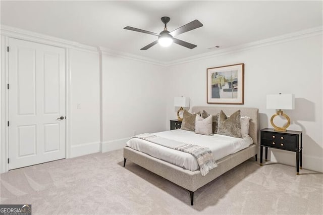 bedroom featuring a ceiling fan, light carpet, crown molding, and visible vents